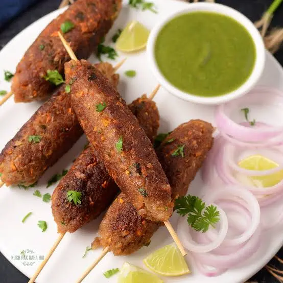 Vegetarian seekh kababs grilled on skewers and served with mint chutney